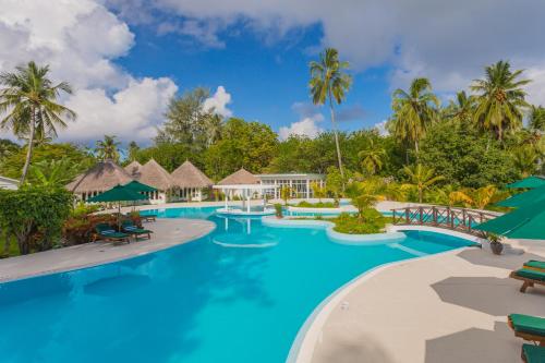 a pool at the resort at Equator Village Maldives in Gan