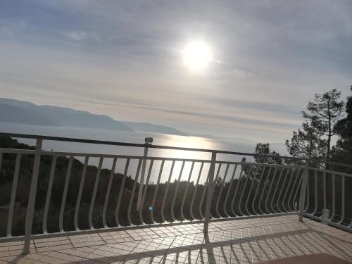 a view of a fence with the sun in the sky at Apartments Plavčić in Plomin