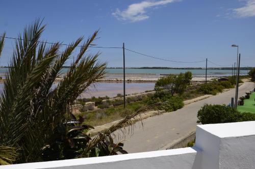 a view of the beach from a house at Apartamentos Eugenio la Sabina in La Savina