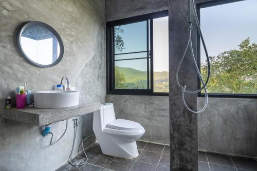 a bathroom with a shower and a toilet and a sink at Deishaview Jungle Hostel in Koh Tao