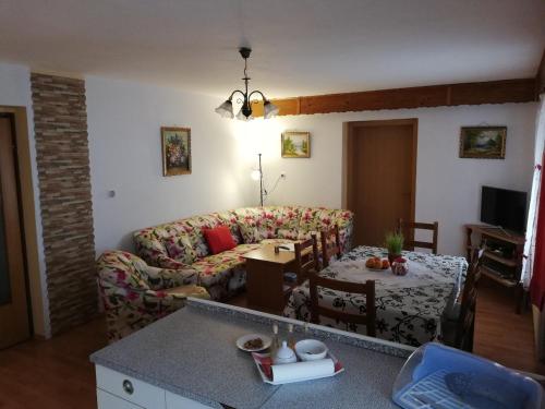 a living room with a couch and a table at Apartment Resman Tršće in Tršće