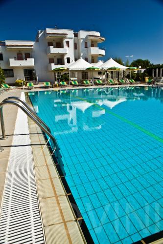 a large swimming pool in front of a building at Residence Atlante in Leporano