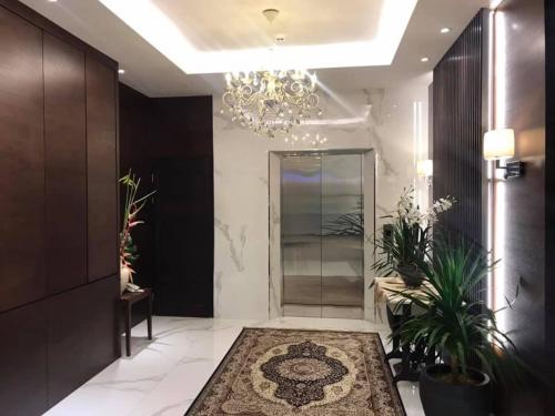 a large hallway with a chandelier and a rug at Serapi Hotel in Kuching