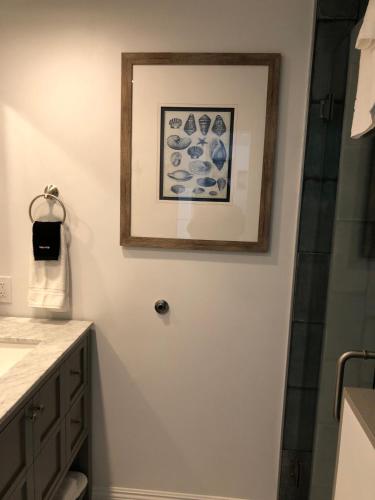 a bathroom with a shower and a picture on the wall at Sea Horse Resort in San Clemente
