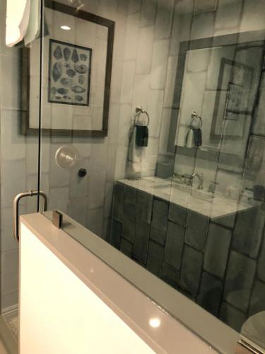 a bathroom with a shower with a glass door at Sea Horse Resort in San Clemente