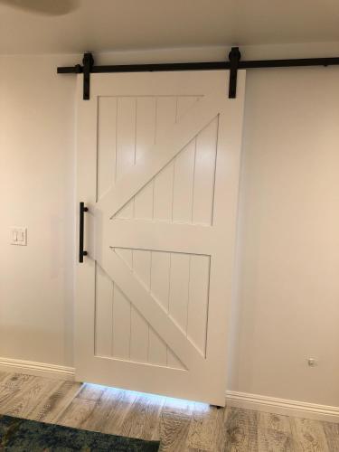 a sliding barn door in a room with wood floors at Sea Horse Resort in San Clemente