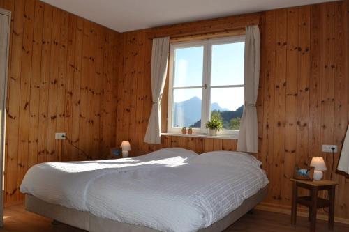 a bedroom with a white bed and a window at Kraxner Haus in Serfaus