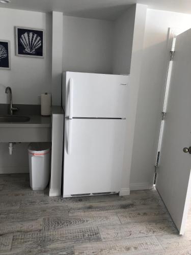 a white refrigerator in a kitchen with a sink at Sea Horse Resort in San Clemente