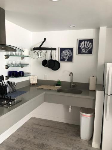 a kitchen with a sink and a counter with pots and pans at Sea Horse Resort in San Clemente