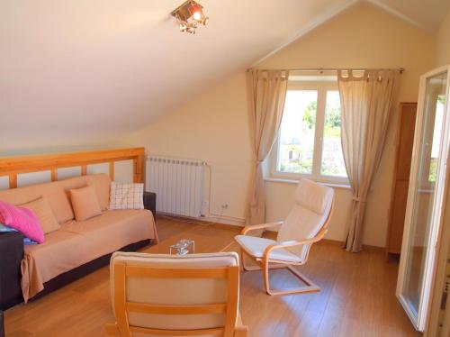 a living room with a couch and a chair at Apartments Lumbarda Beach in Lumbarda