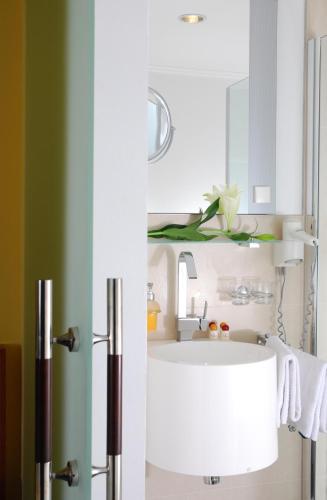 a bathroom with a white sink and a mirror at Hotel ZUM TURM in Kaub