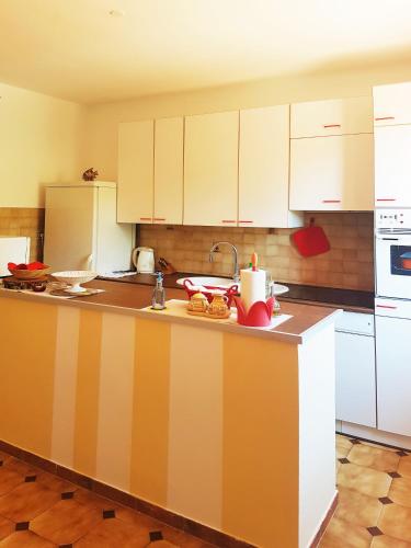 a kitchen with white cabinets and a counter top at Apartments Mare in Pula