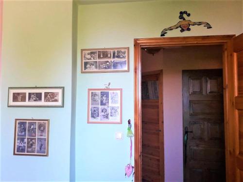 a room with a door and pictures on the wall at Villa Ioanneta in Achladi
