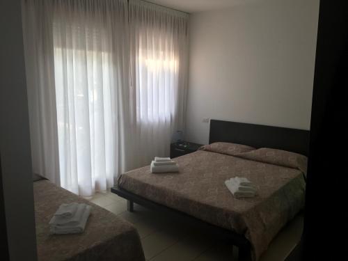 a bedroom with two beds with towels on them at Villa Gentile in Cavallino-Treporti