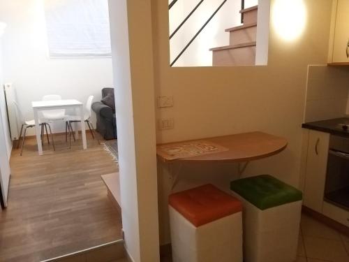 a kitchen and living room with a table and stool at Soliman in Bressanone