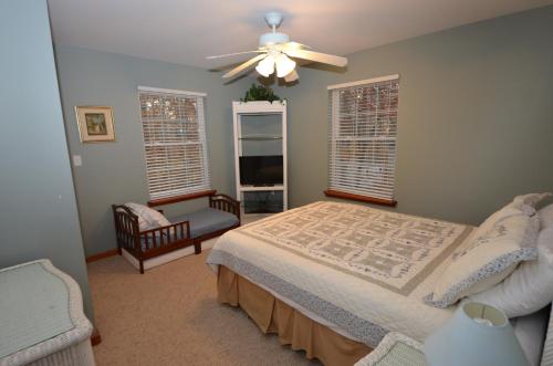 a bedroom with a bed and a ceiling fan at Mt. Maplewood Split Chalet in Pocono Lake