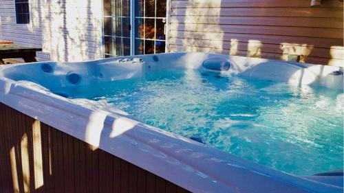 a blue bath tub with water in it at Mt. Maplewood Split Chalet in Pocono Lake