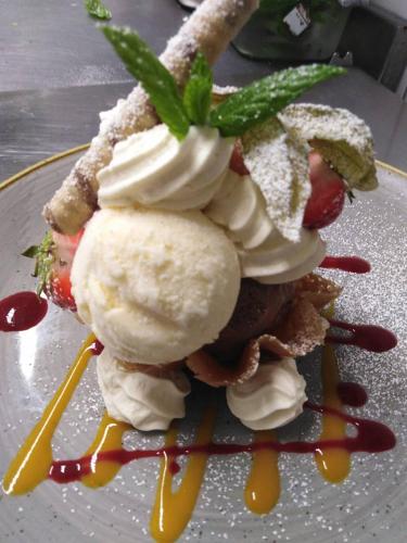 a dessert with ice cream and sauce on a plate at Wilde Ballybunion in Ballybunion