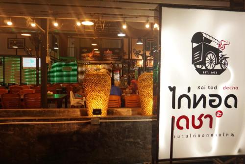a restaurant with a jaguar sign in a window at Khoksametchun Hostel in Hat Yai