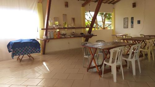 a dining room with tables and chairs and a window at Pousada Vida Mar in Barra Grande