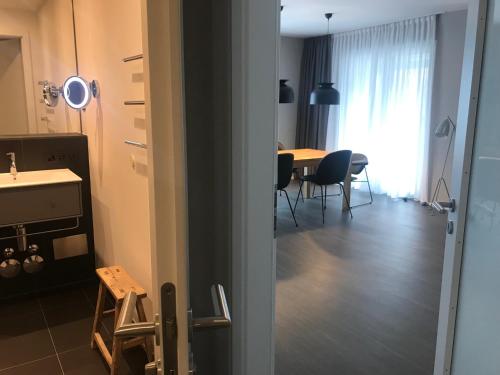 a room with a table and chairs and a dining room at Timehouse Serviced Apartments in Munich