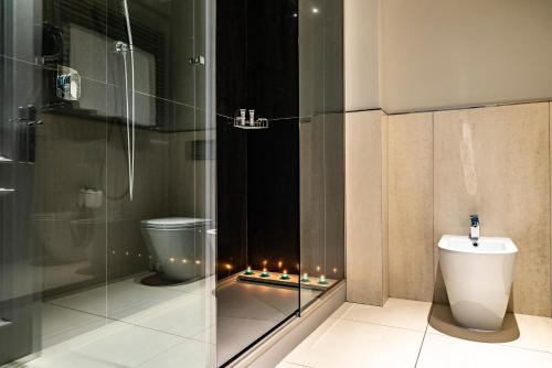 a bathroom with a glass shower and a toilet at Hotel Grande Italia in Chioggia