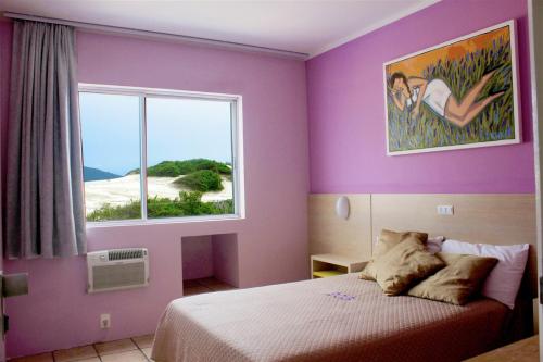Gulta vai gultas numurā naktsmītnē Via Praia Apart Hotel