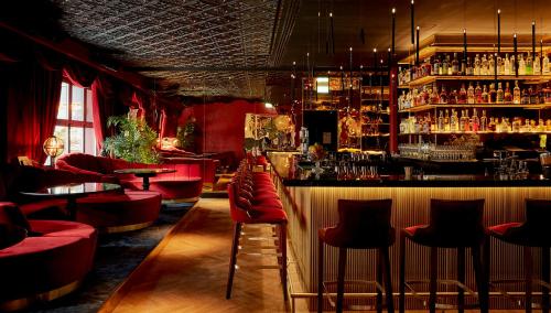 a bar with a lot of tables and chairs at Provocateur Berlin in Berlin