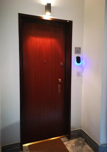 a red door with a light on top of it at 2 Navigli in Milan