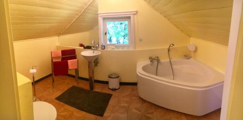 a bathroom with a large tub and a sink at Alpchalet Oberstdorf in Oberstdorf