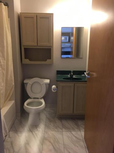 A bathroom at All Suites Inn Budget Host