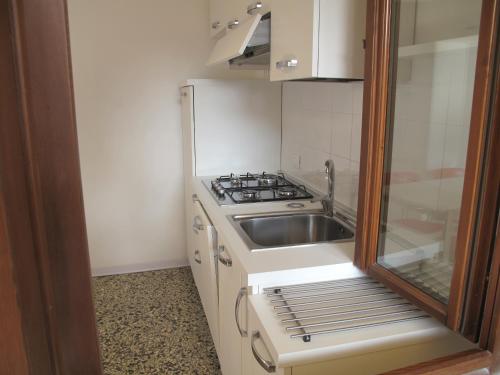 a small kitchen with a sink and a stove at Abitazione Morosini Apartment in Venice