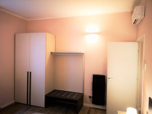 a room with a cupboard and a refrigerator at 2 Navigli in Milan