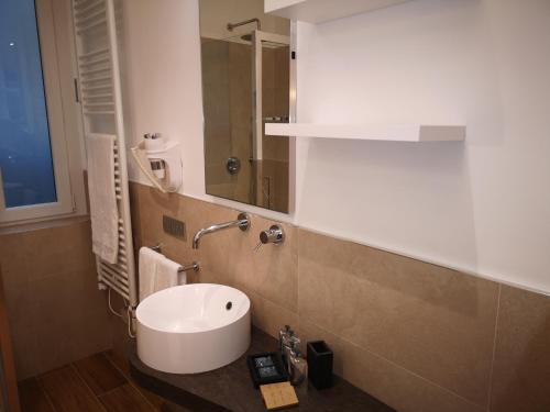 a bathroom with a white sink and a mirror at 2 Navigli in Milan