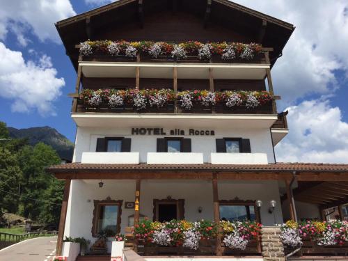 a hotel with flower boxes on the side of a building at Hotel Alla Rocca in Varena