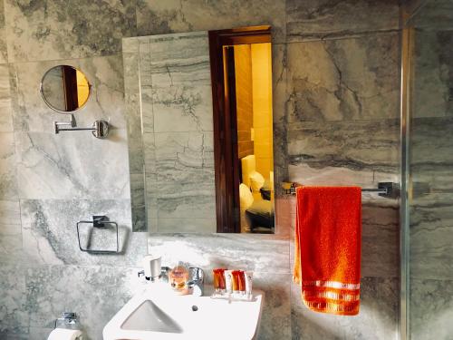 a bathroom with a sink and a mirror at Modern Maltese House in Sliema