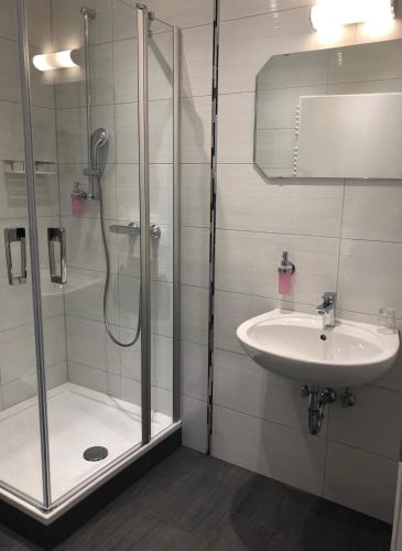 a bathroom with a shower and a sink at Gasthof Zur Krone in Leidersbach