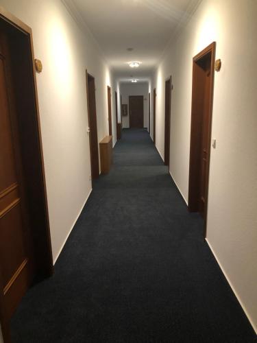 a hallway of an empty hotel room with a long corridor at Gasthof Zur Krone in Leidersbach
