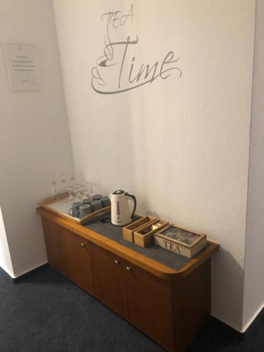 a room with a counter with a tea time sign on the wall at Gasthof Zur Krone in Leidersbach