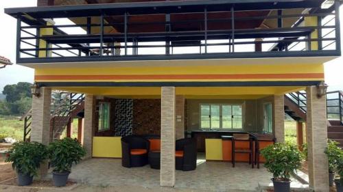 a house with a patio with a bar in it at Ban Thung Talay Mok Chiangdao in Chiang Dao