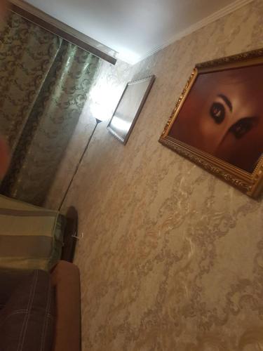 a picture of a face on the wall of a room at Аpartments Rivne Hotel Kvartira Автовокзал Центр in Rivne