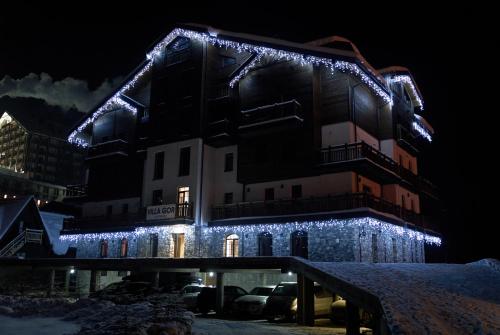 a building with christmas lights on it at night at Villa Gor in Bukovel