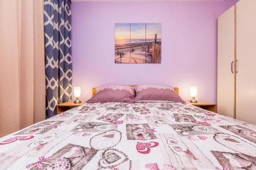 a bedroom with a large bed with two lamps at Apartment Infinity in Rijeka