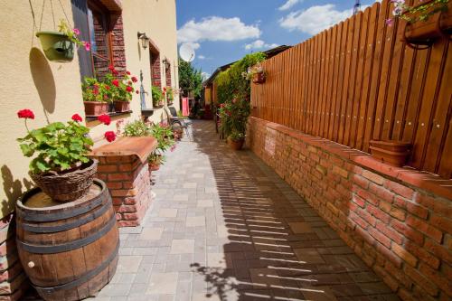 a narrow alley with a brick fence and plants at Penzión pri Kaštieli in Bratislava