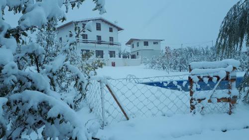 a fence covered in snow in front of a house at Villa SALAM in Ifrane