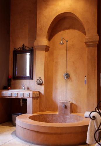 a large tub in a bathroom with a sink at Blue Grass Nest in Nelspruit