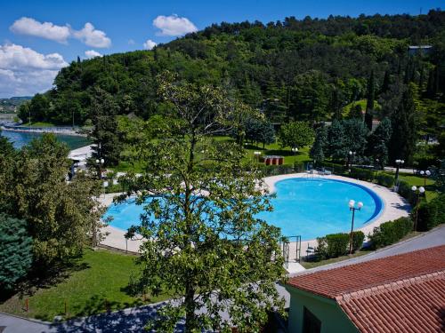 an overhead view of a swimming pool with a mountain at Bioenergy Resort Salinera Hotel in Strunjan