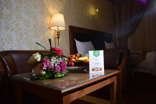 a table in a hotel room with a bowl of fruit at Canary Beach Hotel in Yanbu