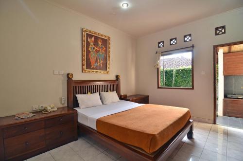 Un dormitorio con una cama grande y una ventana en Taman Ayu 212, en Denpasar