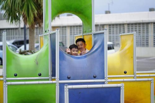 a man and a child on a roller coaster at The BREAKFAST HOTEL MARCHE Ishigaki Island in Ishigaki Island